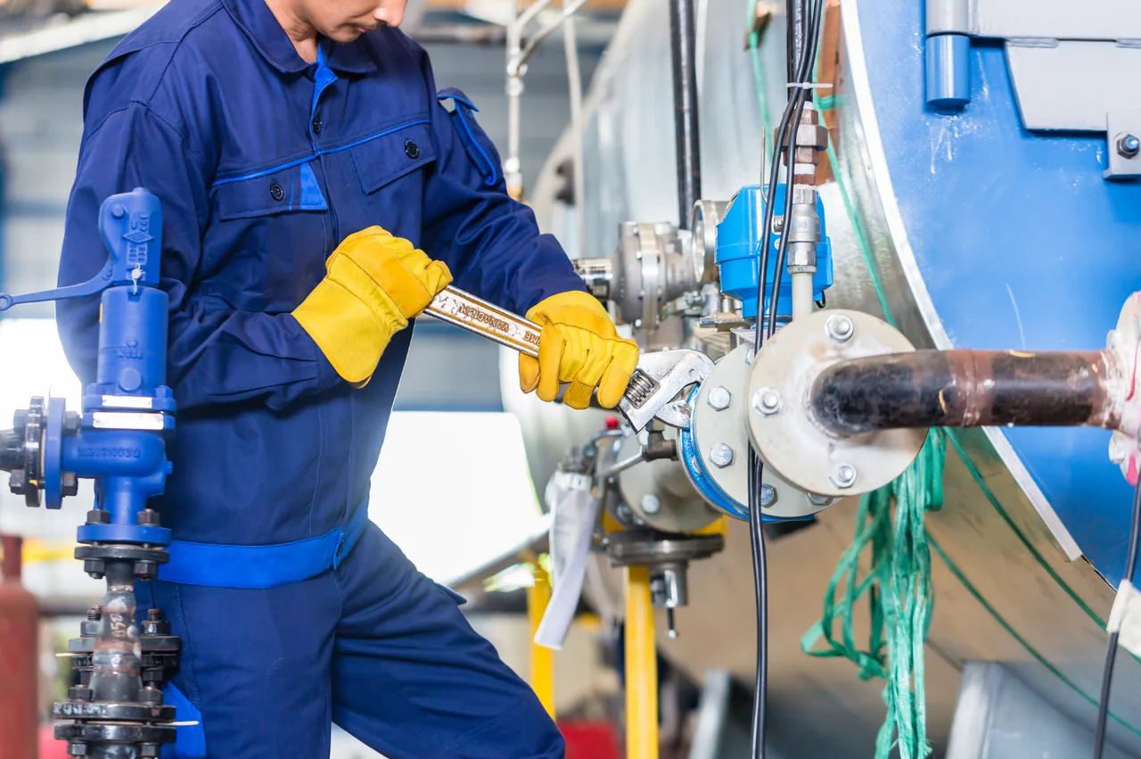 Technician working on industrial piping